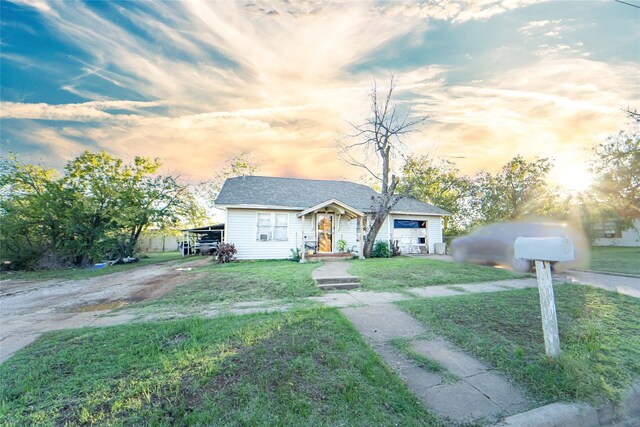 ranch-style home with a yard and a carport