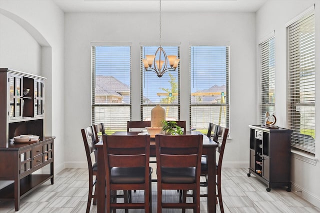 dining space featuring an inviting chandelier and plenty of natural light