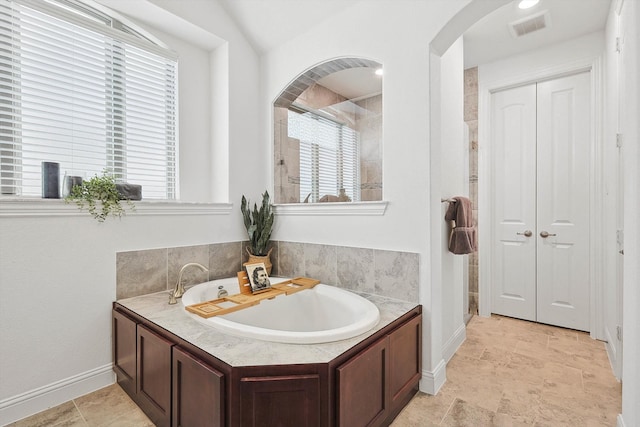 bathroom featuring independent shower and bath