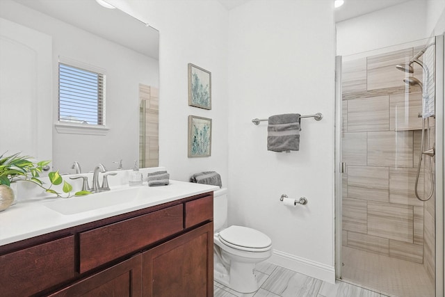 bathroom with a shower with door, vanity, and toilet