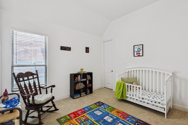 carpeted bedroom with vaulted ceiling and a crib