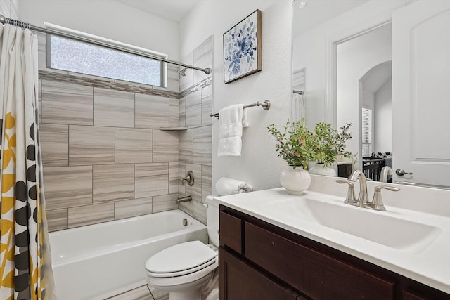 full bathroom featuring shower / bath combo, vanity, and toilet