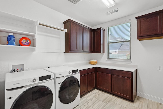 laundry area featuring cabinets and washer and clothes dryer