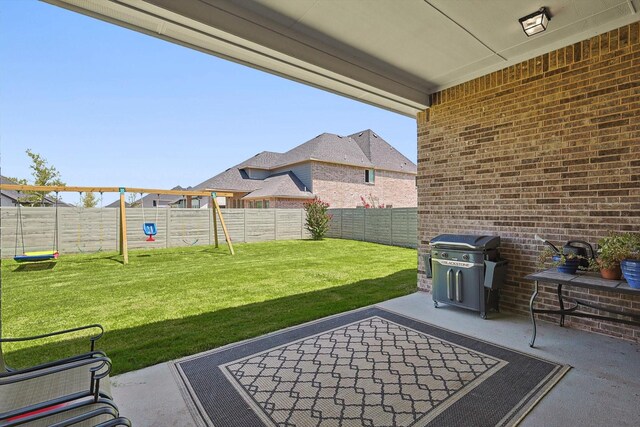 view of patio / terrace with a playground and area for grilling