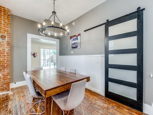 dining room featuring hardwood / wood-style floors and a barn door