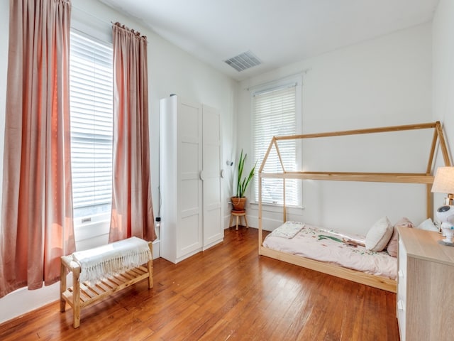 bedroom with hardwood / wood-style floors