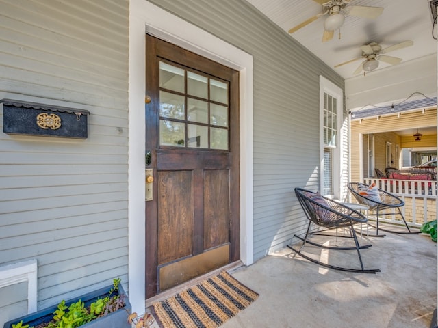 view of exterior entry with covered porch and ceiling fan