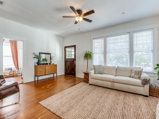 living room with ceiling fan and hardwood / wood-style floors