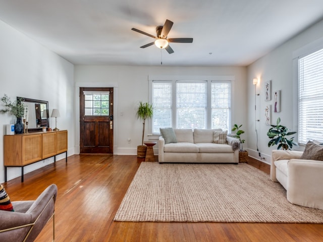 living room featuring wood-type flooring, plenty of natural light, and ceiling fan