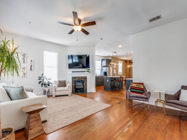 living room featuring hardwood / wood-style flooring and ceiling fan