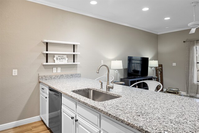 kitchen with white cabinets, light stone counters, ceiling fan, sink, and dishwasher