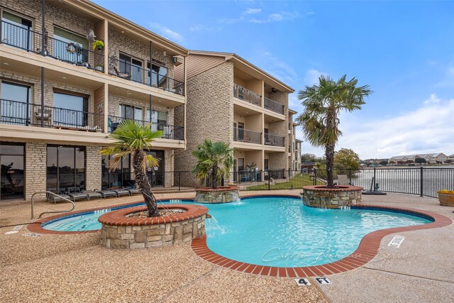 view of swimming pool featuring pool water feature