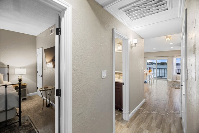 corridor featuring crown molding and wood-type flooring