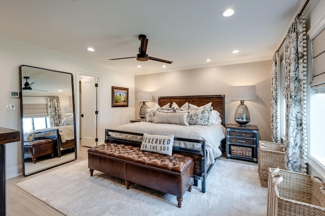 bedroom featuring crown molding, ceiling fan, and light wood-type flooring