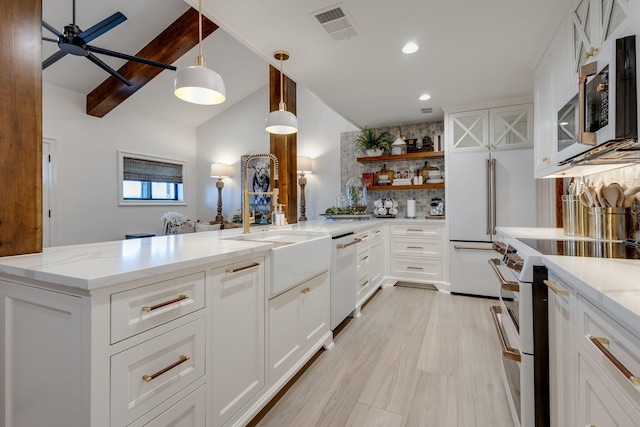 kitchen with white cabinetry, light stone counters, hanging light fixtures, ceiling fan, and white appliances