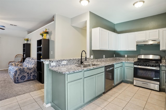 kitchen featuring gas stove, white cabinetry, sink, black dishwasher, and kitchen peninsula