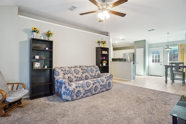 living room with light colored carpet and ceiling fan