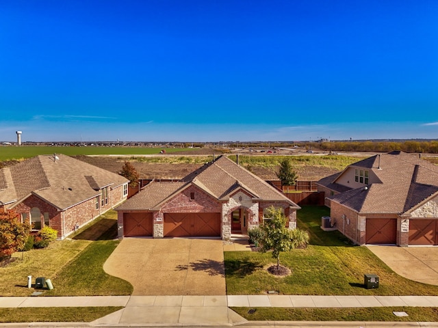 view of front of property featuring a garage and a front yard