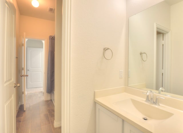 bathroom with hardwood / wood-style flooring and vanity