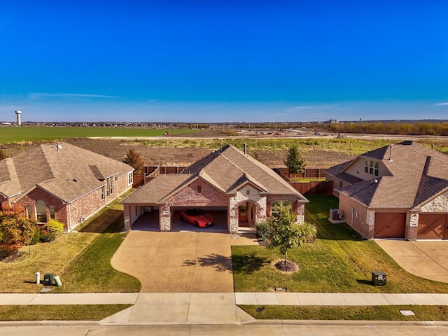 view of front of property featuring a front lawn and a garage