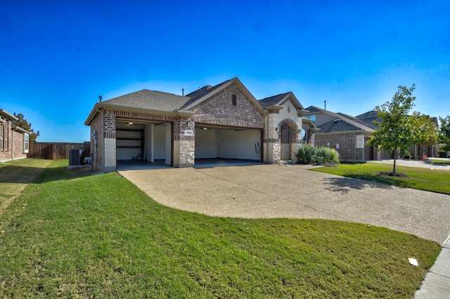 view of front of property with a garage, a front lawn, and central air condition unit