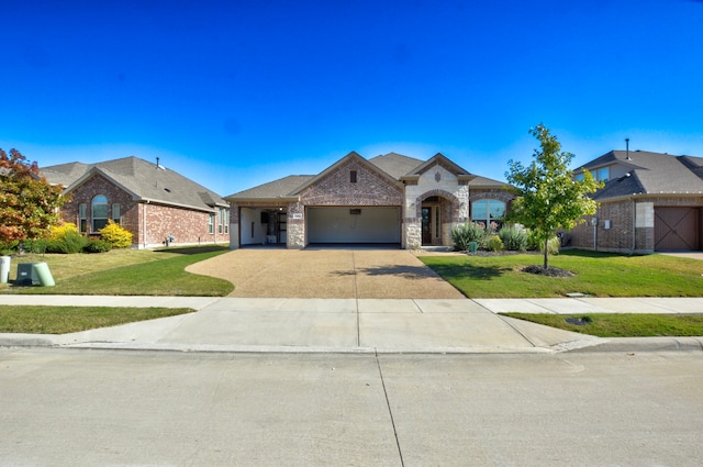 view of front of house featuring a garage and a front lawn