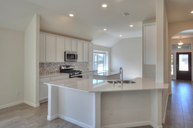 kitchen with appliances with stainless steel finishes, white cabinetry, and sink