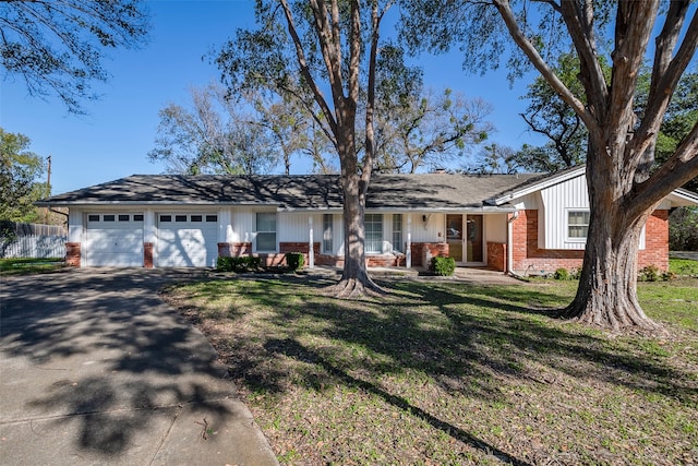 single story home with a front yard and a garage