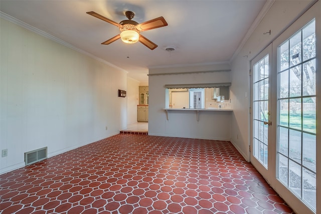 unfurnished living room with ceiling fan, crown molding, and french doors