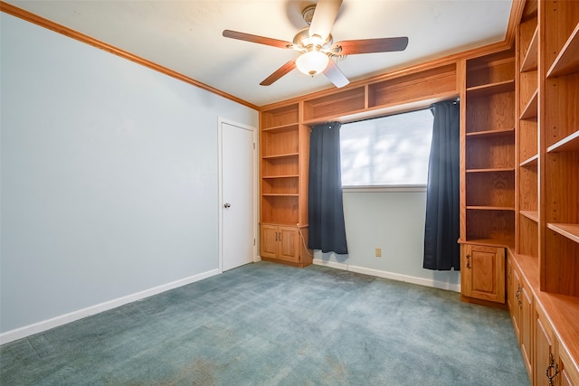 unfurnished bedroom featuring ceiling fan, dark carpet, and ornamental molding