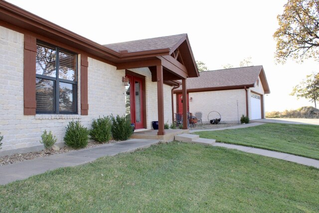 view of front of property with a front yard and a garage