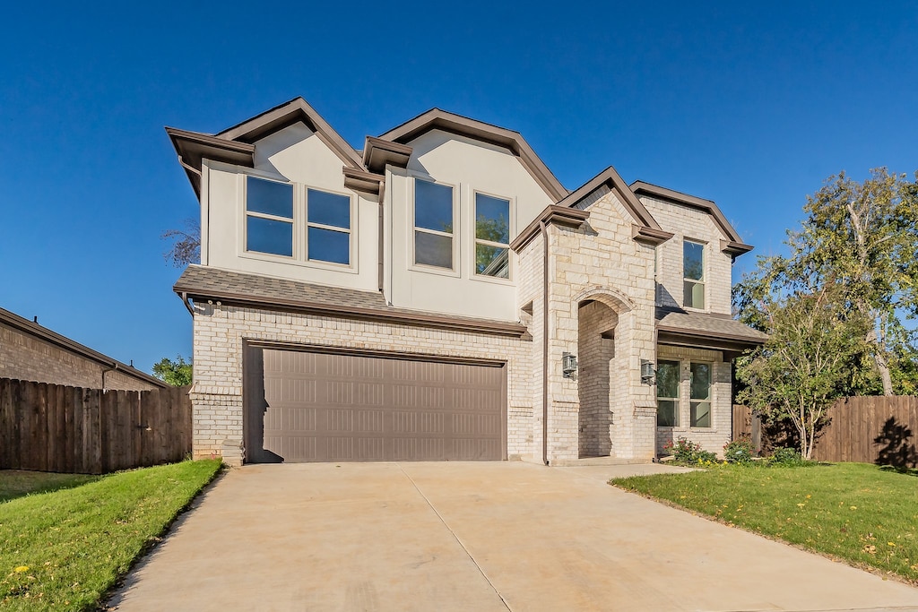 view of front of property with a garage and a front yard