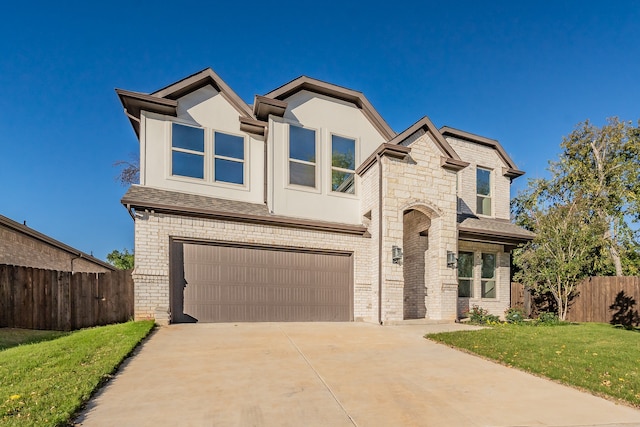 view of front of property with a garage and a front yard