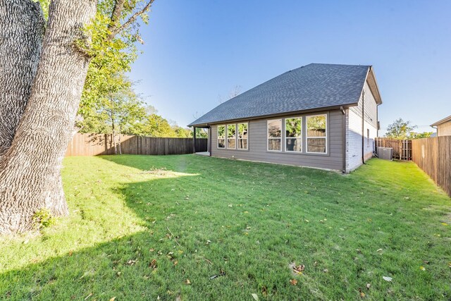 exterior space featuring a lawn and central AC unit