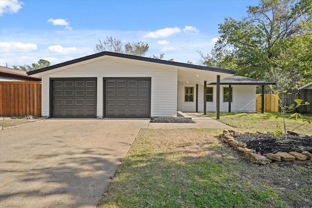 view of front of home featuring a garage and a front lawn