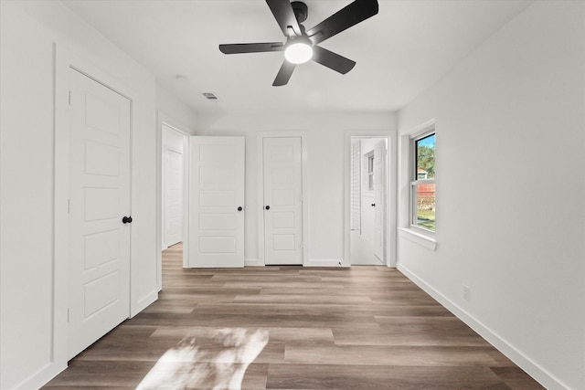 unfurnished bedroom featuring hardwood / wood-style flooring and ceiling fan