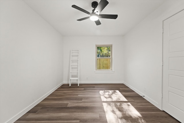 spare room featuring dark hardwood / wood-style flooring and ceiling fan