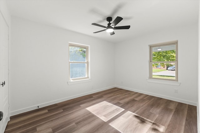 spare room with dark wood-type flooring and ceiling fan