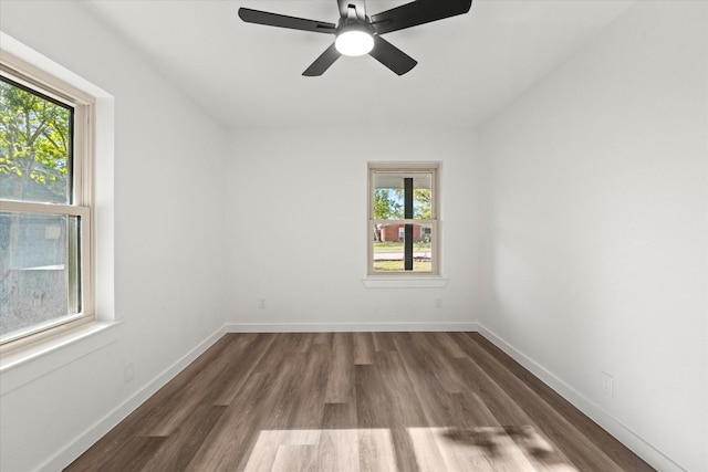 spare room featuring dark wood-type flooring and ceiling fan