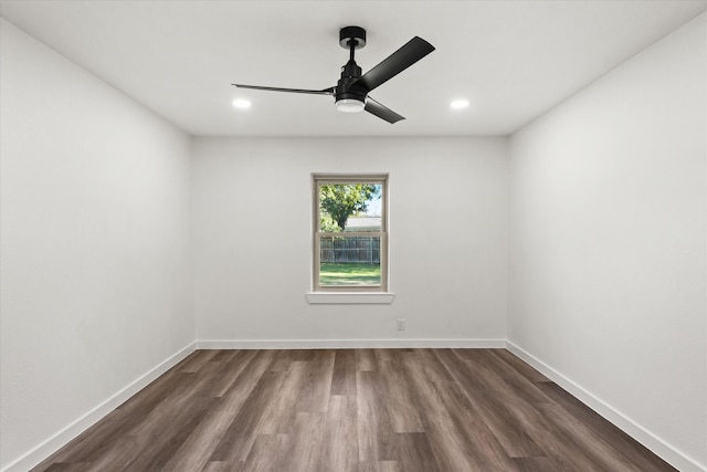 empty room featuring dark wood-type flooring and ceiling fan