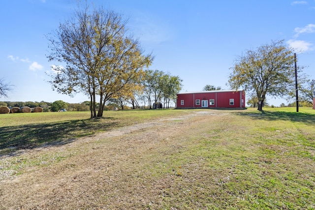 view of yard with a rural view and an outbuilding