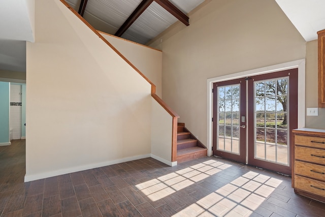 foyer with beam ceiling, high vaulted ceiling, french doors, and dark wood-type flooring