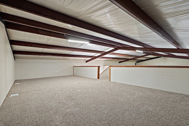 interior space featuring vaulted ceiling with beams and carpet floors