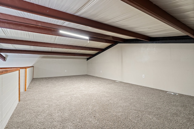 additional living space featuring carpet floors and lofted ceiling with beams