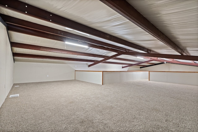 bonus room with carpet and beam ceiling