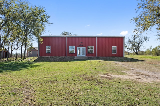 view of outbuilding featuring french doors and a lawn