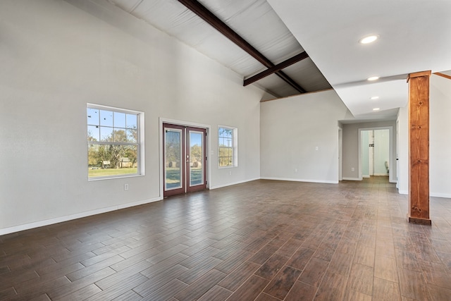 unfurnished living room with beamed ceiling, dark hardwood / wood-style flooring, and high vaulted ceiling