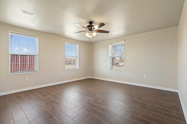 spare room with dark hardwood / wood-style floors and ceiling fan