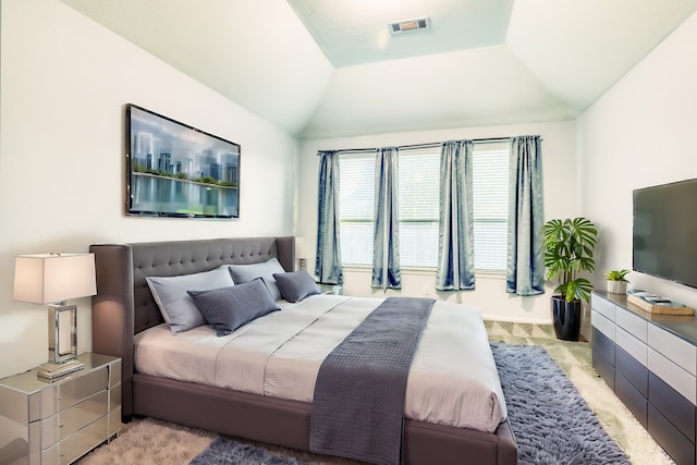 carpeted bedroom featuring lofted ceiling