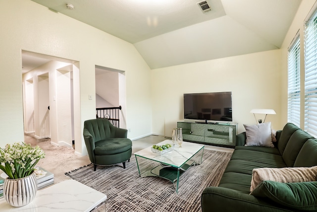 living room featuring carpet floors and vaulted ceiling